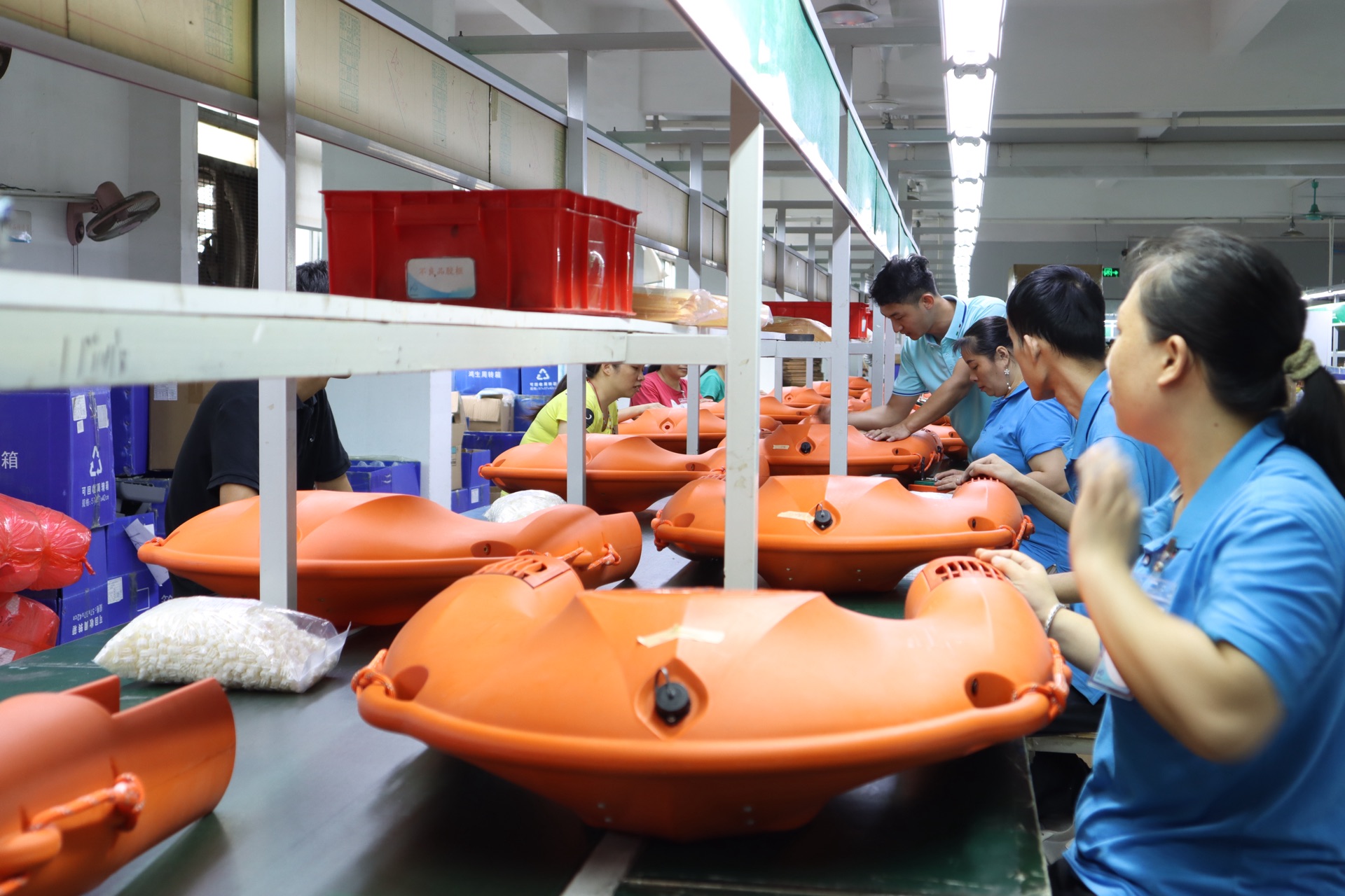Workers assembling XHX rescue craft on the production line in Shenzhen